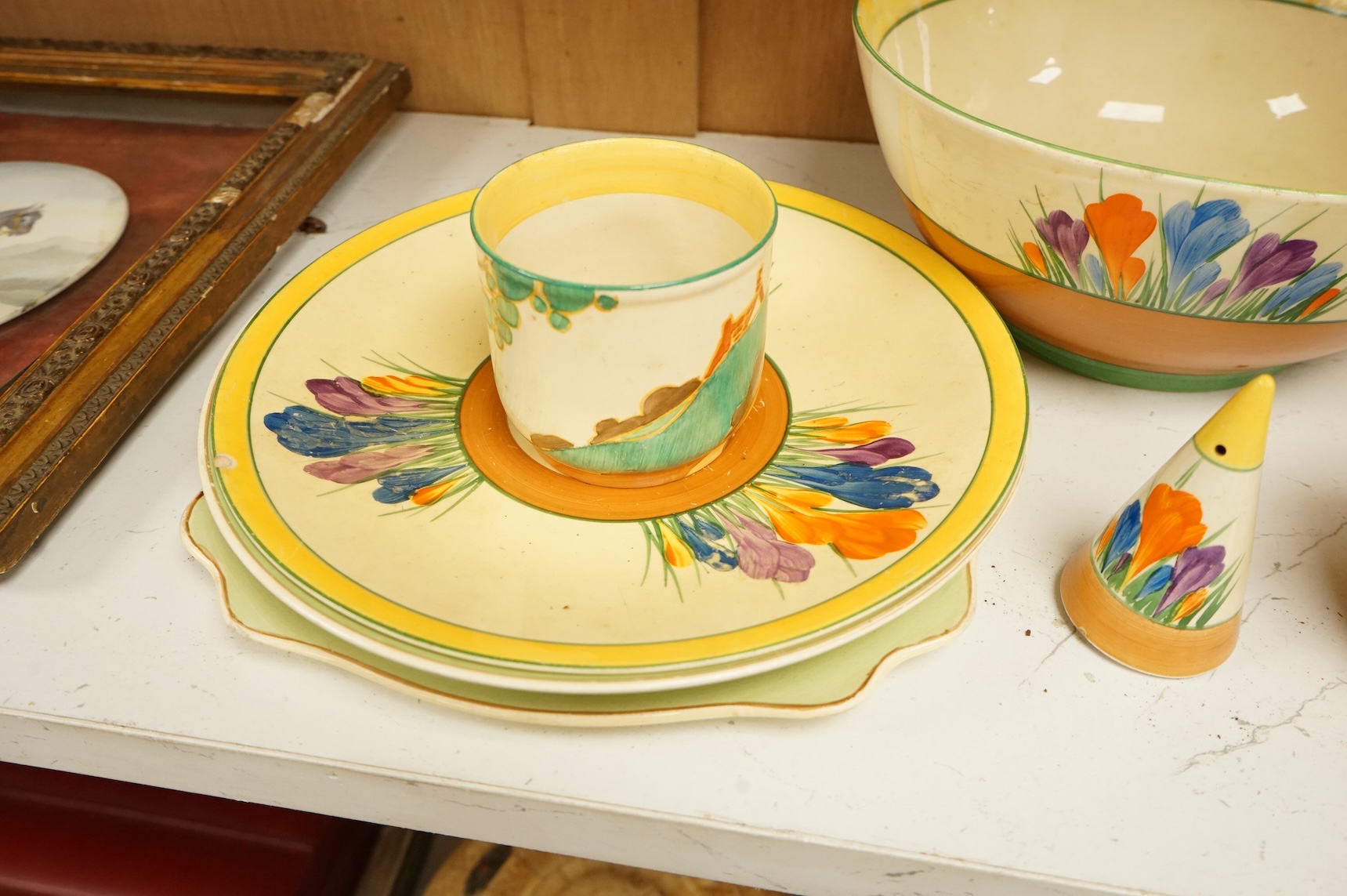 Collection of Clarice Cliff crocus pattern tea wares to include trios, milk jug, and a bowl, largest 22cm in diameter